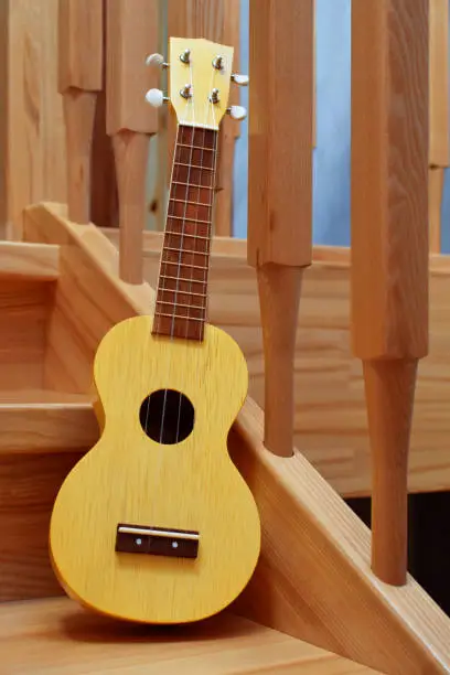 Photo of Yellow traditional soprano ukulele guitar