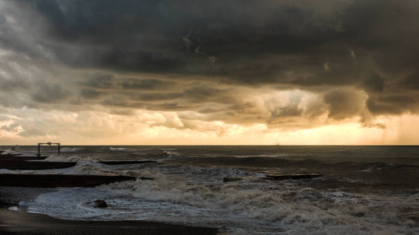 Storm waves over a pier in the Adler, Sochi
