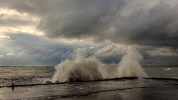 istock Storm waves over a pier in the Adler, Sochi 1130414459