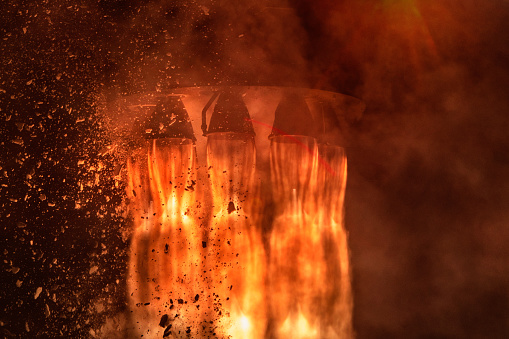 Rocket engines and fire duting the missile launch at night, close up conceptual image. Elements of this image furnished by NASA.