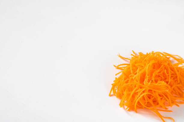 istock Bright orange fresh grated carrot on the white empty background for copy space, Ingrediend. Vegetable. Close up. Healthy. Texture. Isolated 1130416070