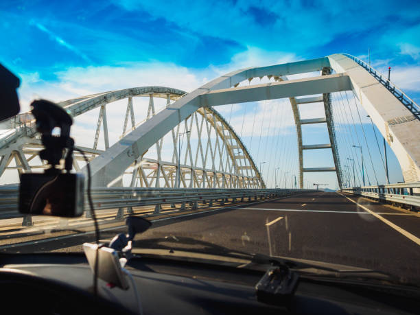 New bridge over the sea channel. Driving along the bridge New bridge over the sea channel between the mainland and the peninsula opening bridge stock pictures, royalty-free photos & images