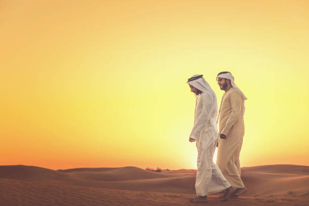 istock Arab Men Enjoying their Walk during Sunset at the Desert 1130420030