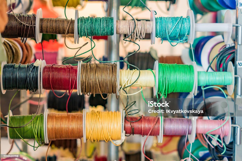 Set of spools with leather rope of different colors for sewing or crafting on  market Abstract Stock Photo