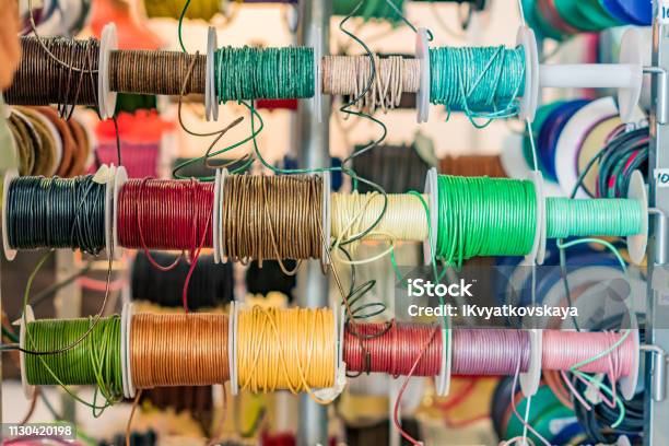 Set Of Spools With Leather Rope Of Different Colors For Sewing Or Crafting On Market Stock Photo - Download Image Now