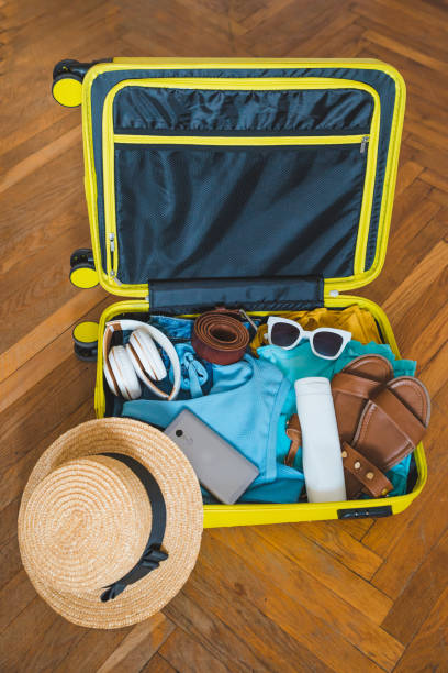istock travel concept. yellow suitcase with different stuff around it 1130422055