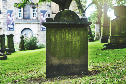 Shot of a gravestone in a cemetery