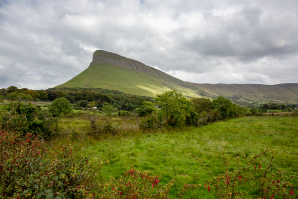 istock Typical Irish landscape with dark grey clouds, rain and mountains 1130426448