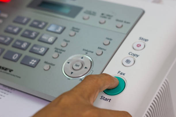 hand man are using a fax machine in the office stock photo