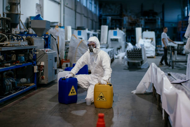 istock Factory worker wearing gas mask and radioactive protection suit 1130429143