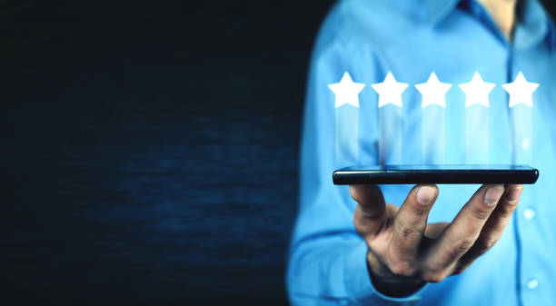 istock Man holding phone with five stars. Increase rating 1130429177
