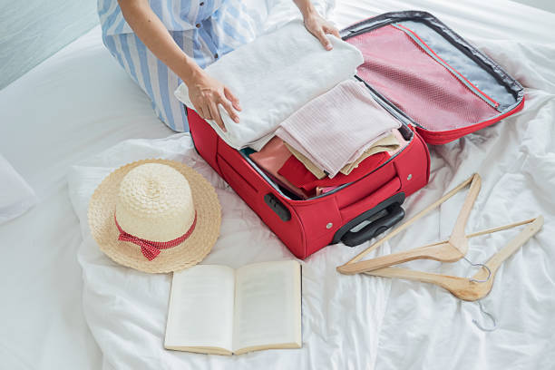 istock People packed suitcase with travel accessories on bed. Vacation concept 1130430528