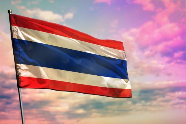 istock Fluttering Thailand flag on colorful cloudy sky background. Prosperity concept. 1130430706