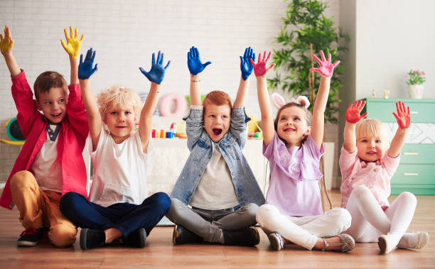 Group of children with colorful, painted hands Group of children with colorful, painted hands preschool building photos stock pictures, royalty-free photos & images