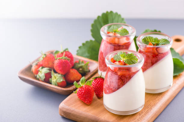 istock Delicous and nutritious double color (colour) strawberry desserts with mint and diced sarcocarp topping isolated with airy blue background, copy space, close up 1130434975