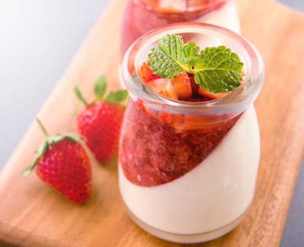 istock Delicous and nutritious double color (colour) strawberry desserts with mint and diced sarcocarp topping isolated with airy blue background, copy space, close up 1130435036