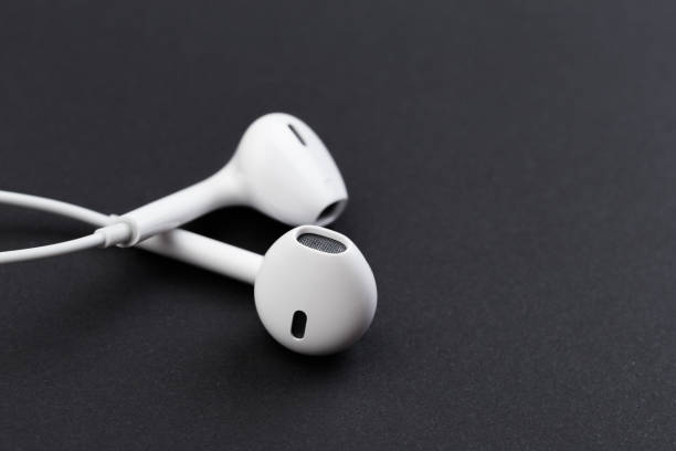 istock white earphones on black background 1130435124