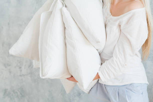 istock quality bedding sound sleep woman hold pillows 1130437970