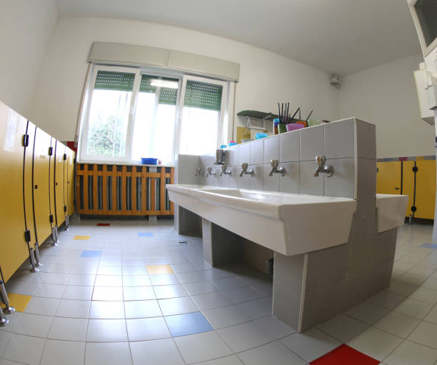 istock interior of the school bathrooms with ceramic sinks and yellow d 1130439083