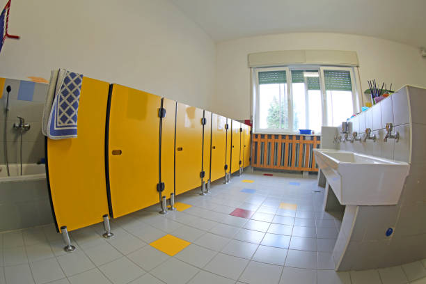 istock toilets of the school and ceramic sinks and yellow doors without 1130439540