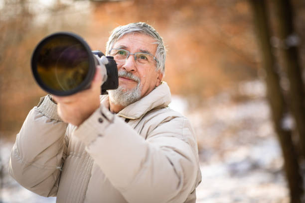 istock Senior man devoting time to his favorite hobby - photography 1130442281