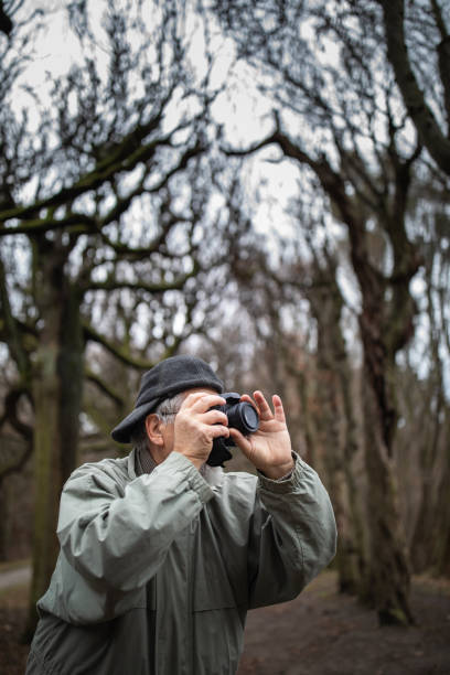 istock Senior man devoting time to his favorite hobby - photography 1130442283