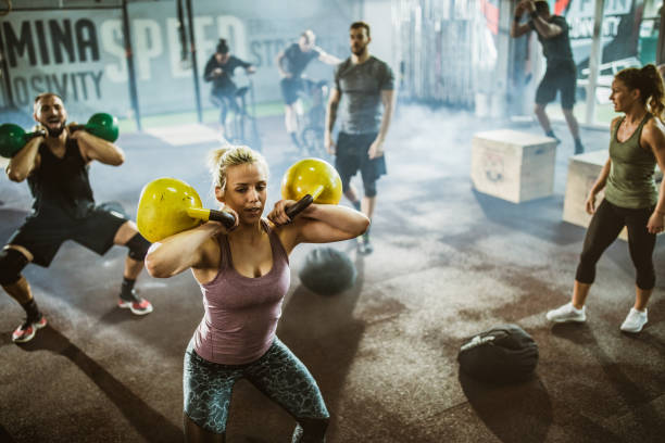 istock Large group of athletic people having gym training in a gym. 1130442721
