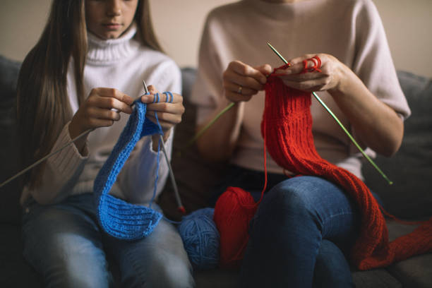 istock Mother and daughter knitting at home 1130443898
