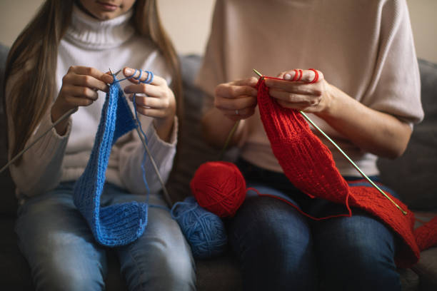 istock Mother and daughter knitting at home 1130443967