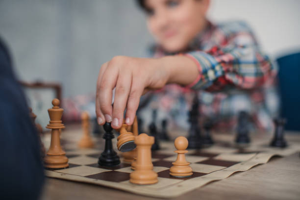 istock Boy making a move in game of chess 1130444174