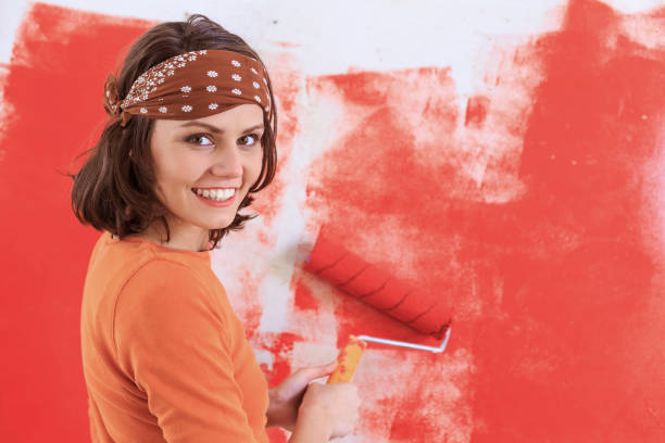 istock Woman making home improvement in red 1130446025
