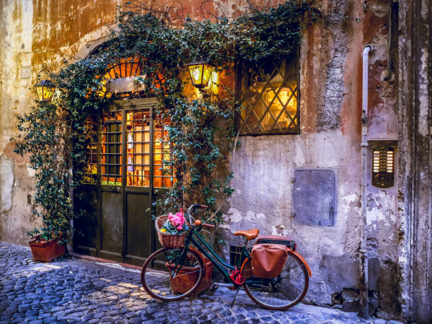 A picturesque Italian restaurant in the ancient Trastevere district in the historic heart of Rome Rome, Italy, Feb 17 - A view of a typical alley in the Roman district of Trastevere, one of the oldest and most characteristic of the city of Rome. Built since the Imperial era, Trastevere owes its name to its position, beyond the Tiber River. cobblestone photos stock pictures, royalty-free photos & images