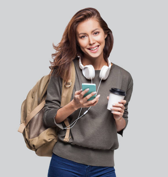 istock Happy young student girl using smart phone 1130448769