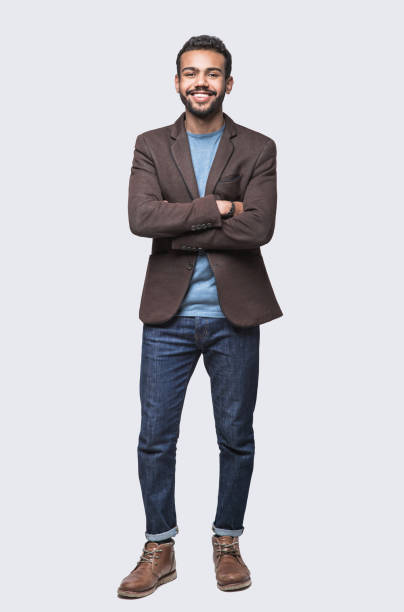 Full length portrait of handsome smiling young man Cheerful young men studio shot. Isolated on gray background middle eastern ethnicity photos stock pictures, royalty-free photos & images