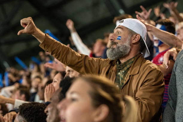 istock Group of spectators cheering in stadium 1130450559