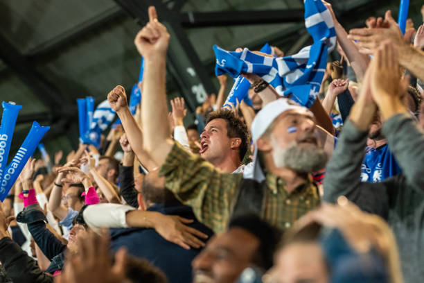 istock Group of spectators cheering in stadium 1130450563