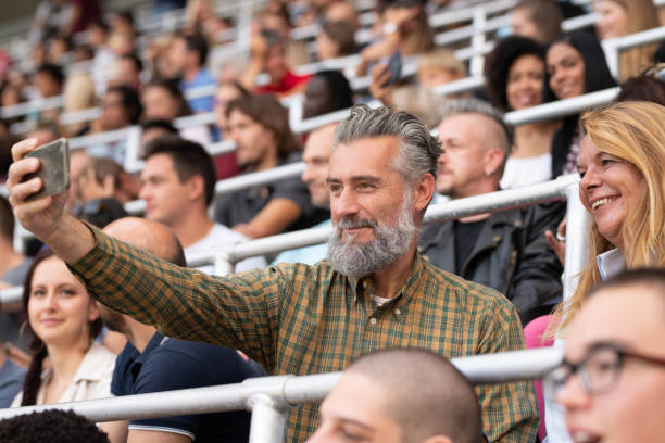 istock Group of spectators cheering in stadium 1130450576
