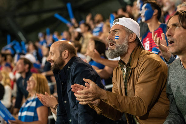 istock Group of spectators cheering in stadium 1130450580
