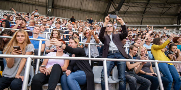 istock Group of spectators cheering in stadium 1130450598