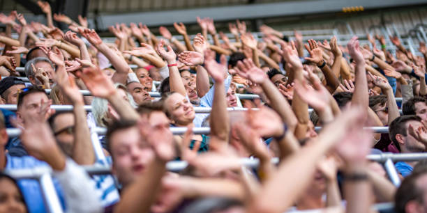 istock Group of spectators cheering in stadium 1130450603