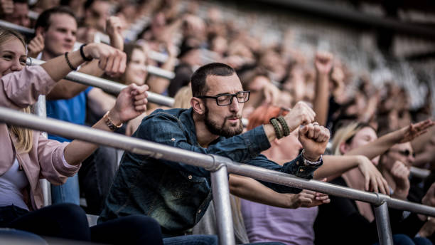 Group of spectators cheering in stadium