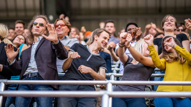 istock Group of spectators cheering in stadium 1130450608