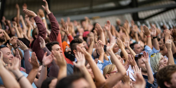 istock Group of spectators cheering in stadium 1130450613