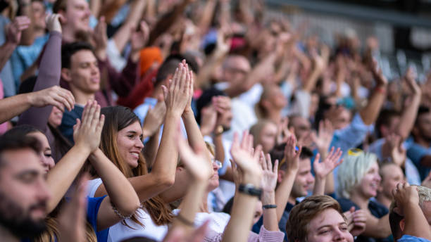 istock Group of spectators cheering in stadium 1130450615