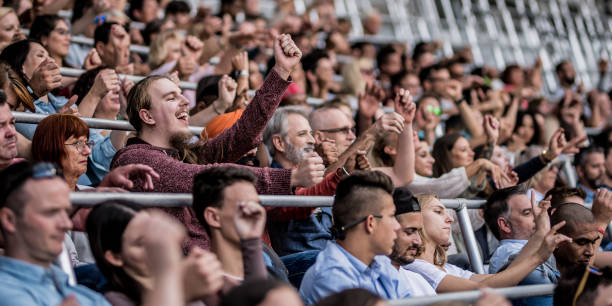 istock Group of spectators cheering in stadium 1130450622