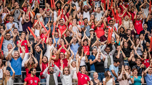istock Group of spectators cheering in stadium 1130450690