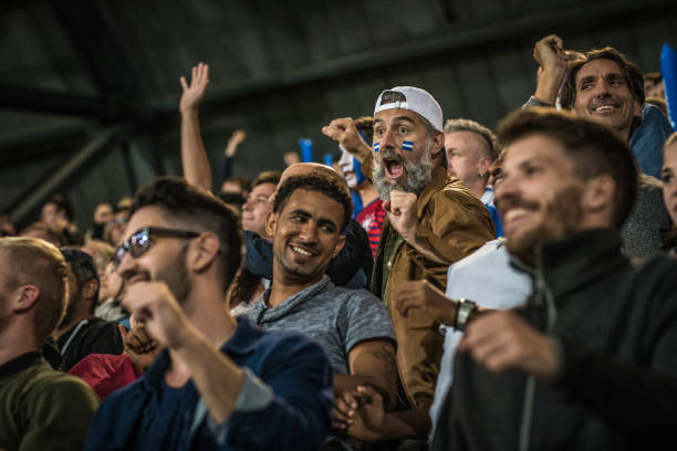 istock Group of spectators cheering in stadium 1130450704