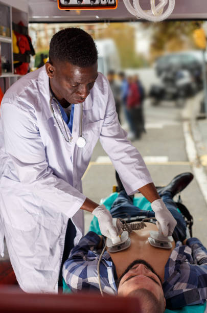 istock Doctor resuscitating patient with help of defibrillator 1130451818