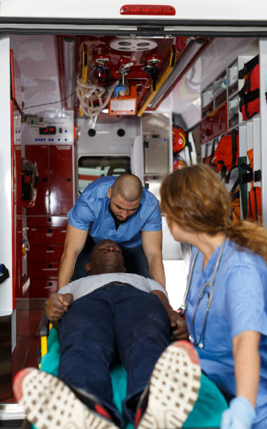 istock Ambulance team laying patient on stretcher 1130451834