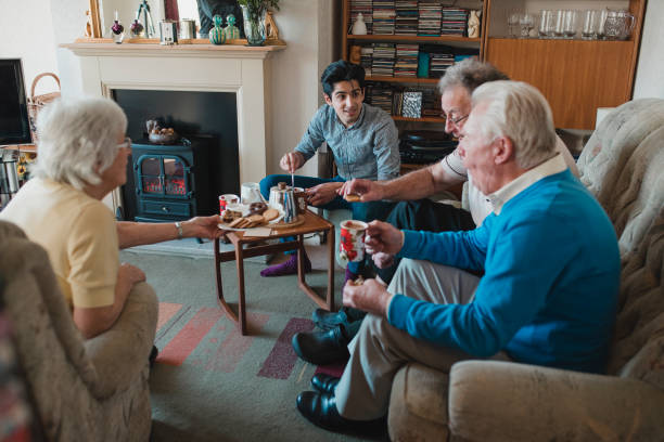 Teenager Assisting a Senior Tea Party